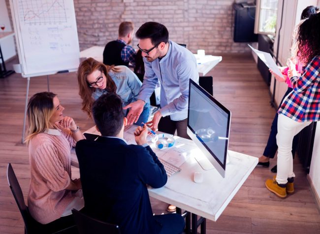 picture-of-young-architects-discussing-in-office-UGKJXLQ-scaled.jpg